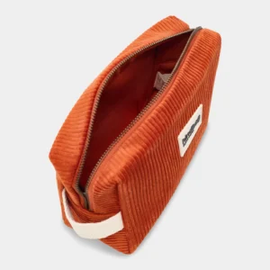 Orange corduroy zippered pouch with a cream strap, opened to reveal red interior lining.