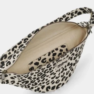 Leopard print canvas crossbody bag with zip top, beige lining, and an inner pocket visible inside.