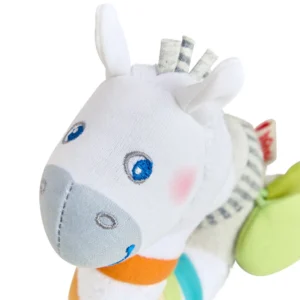 Soft white plush zebra toy with blue embroidered eyes and light gray muzzle, wearing colorful pastel patches.